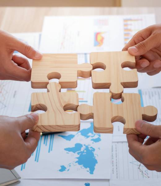 Concept of teamwork, cooperation and partnership. Business people connecting puzzle pieces in office. teamwork, Unity, volunteer, success and strategy.  Business idea by merging jigsaw puzzle.